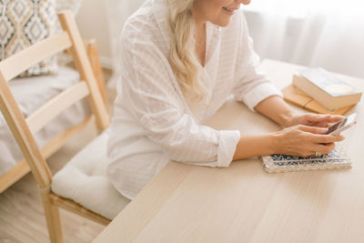 High angle view of woman sitting on table at home