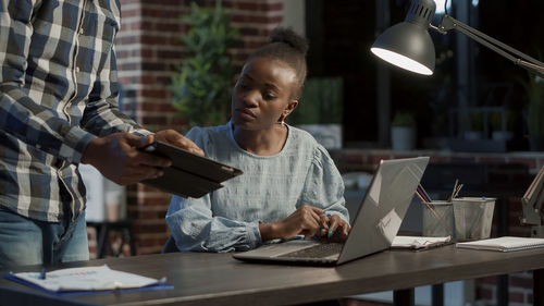 Midsection of businessman having discussion with businesswoman