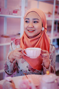 Portrait of a smiling young woman with ice cream