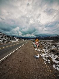 Rear view of man walking on road