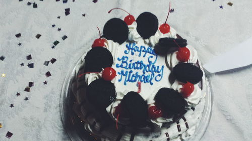 High angle view of birthday cake with text on table