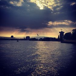 Scenic view of sea against cloudy sky at sunset