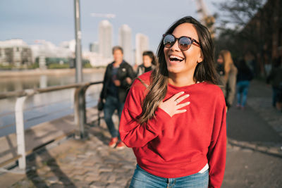 Close-up of smiling young woman standing outdoors