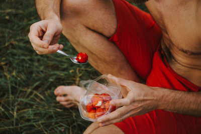 Midsection of man holding ice cream