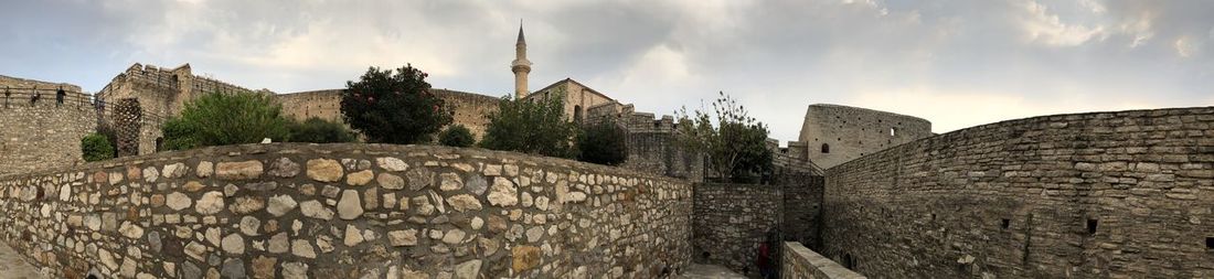 Panoramic view of castle against cloudy sky