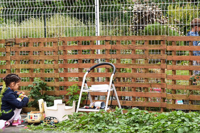 Man sitting on chair against plants