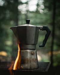 Close-up of coffee cup on barbecue grill