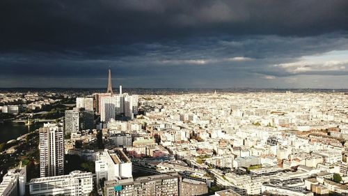 View of cityscape against cloudy sky