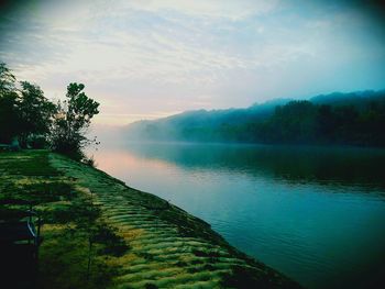 Scenic view of lake against sky at sunset