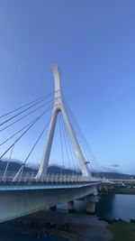 Low angle view of suspension bridge against sky