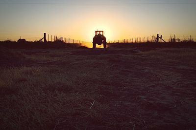 Scenic view of field against sky at sunset
