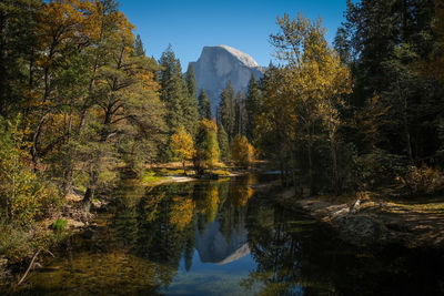 Scenic view of lake by trees against sky during autumn