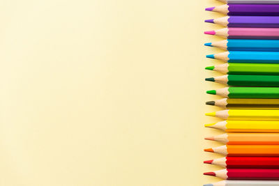 Close-up of multi colored pencils on table