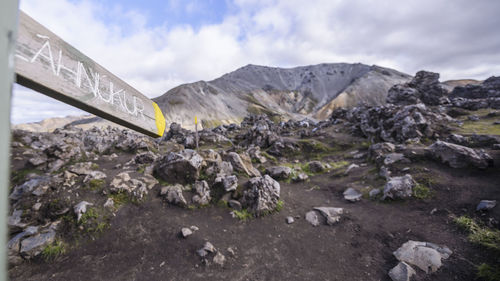 High angle view of text on rock against sky