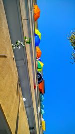 Low angle view of built structure against clear blue sky