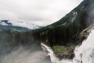 Scenic view of waterfall against sky