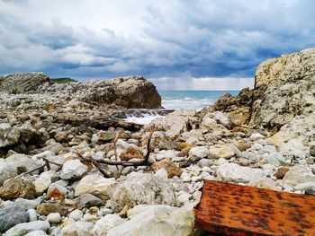 Rocks on beach against sky