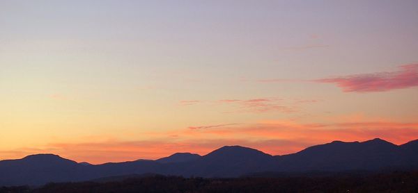 Scenic view of silhouette mountains against sky during sunset