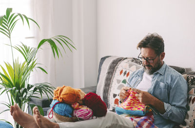 Portrait of man with dog at home