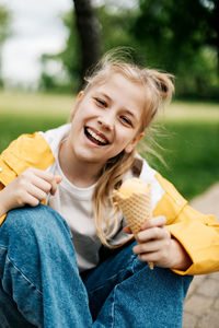 Portrait of smiling woman eating ice cream