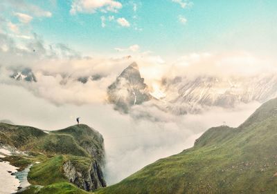 Scenic view of mountains against cloudy sky