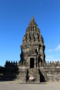 Low angle view of temple against clear blue sky