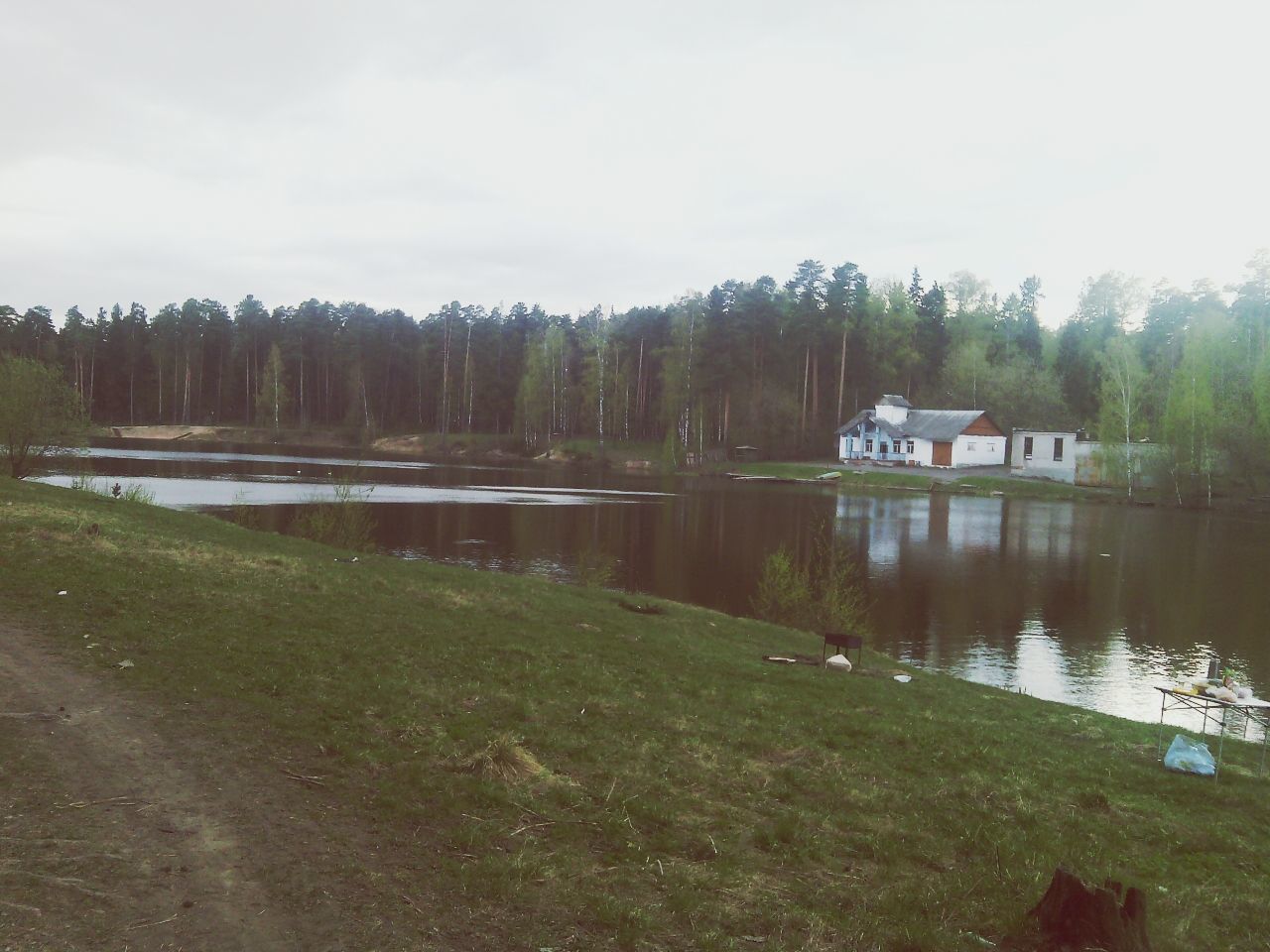 water, lake, built structure, tree, tranquility, sky, building exterior, tranquil scene, grass, architecture, house, nature, scenics, beauty in nature, reflection, river, lakeshore, day, outdoors, plant