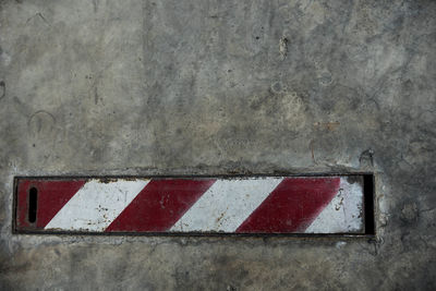 Close-up of arrow sign on wall