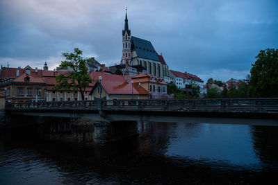 Building by river against sky