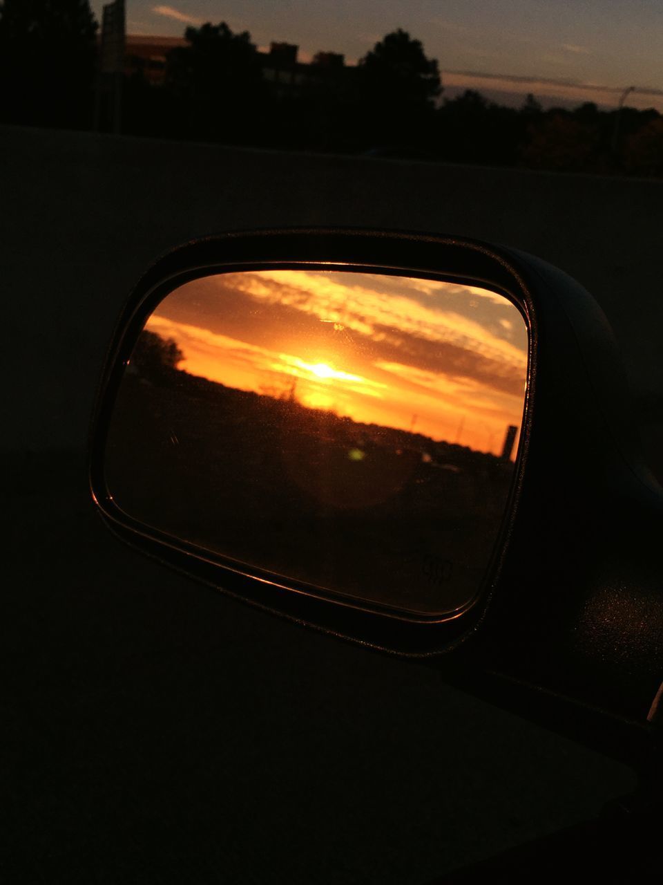 REFLECTION OF SKY ON SIDE-VIEW MIRROR