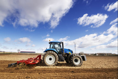 Tractor modern , farm equipment woriking in field