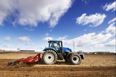 Tractor on field against sky