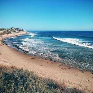 Scenic view of beach against clear sky