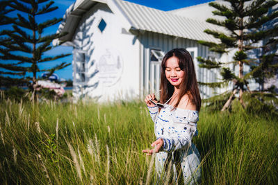 Young woman standing on field