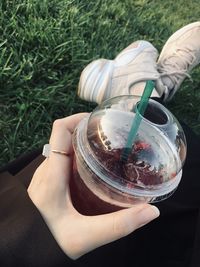 Midsection of woman holding drink