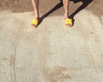 Low section of man in yellow footwear