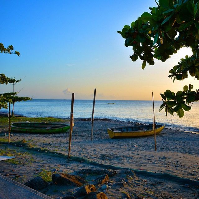 sea, horizon over water, water, beach, tranquil scene, tranquility, beauty in nature, scenics, shore, nature, blue, sand, tree, clear sky, idyllic, sky, nautical vessel, sunlight, vacations, no people