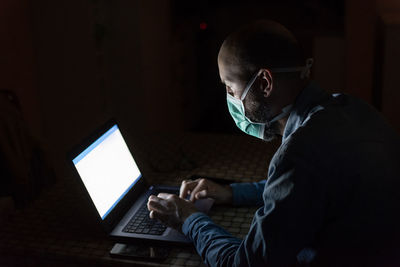 Side view of man working at office