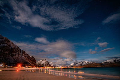 Scenic view of lake against sky at night