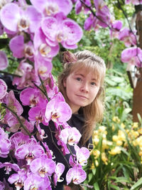 Portrait of woman with pink flowers