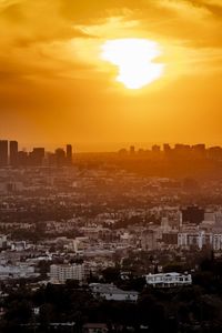 Aerial view of buildings against sky during sunset