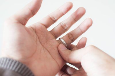 Close-up of hand holding cigarette