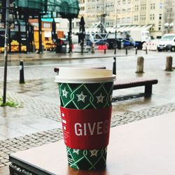 Close-up of coffee cups on street in city