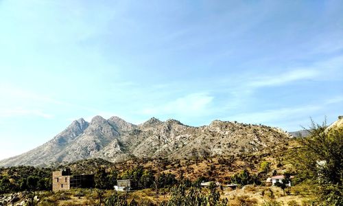 Scenic view of mountains against blue sky