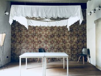 Empty chairs and tables against wall at home