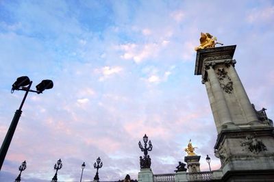 Low angle view of building against cloudy sky