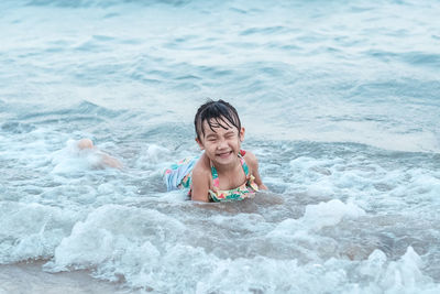 High angle view of boy swimming in sea