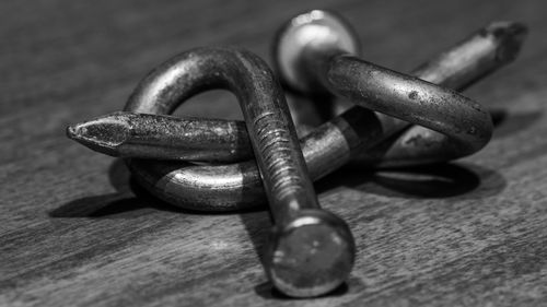 Close-up of rusty chain on table