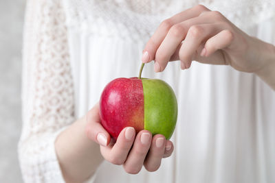 Close-up of woman holding apple