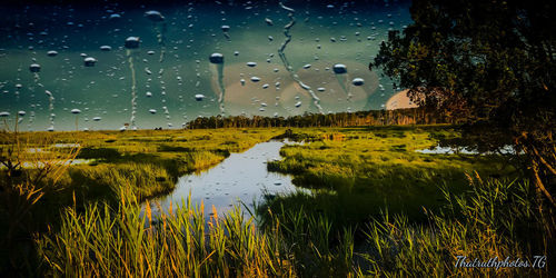 Scenic view of lake against sky during rainy season